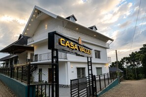 A two-story building with a sign reading 'Casa Valley' and a staircase leading to the entrance. - Casa Valley (Munnar)