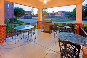 An outdoor patio with a grill, tables, and chairs. - Family Vacation Retreat! 2 Modern Suites | Onsite Parking | 1.2 Mi to Six Flags (Arlington)