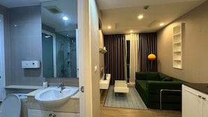 A modern bathroom with a sink, toilet, and shower area. - Relax, Stay and Enjoy Bangsean. Nearby Attractions & Amenities. (Tambon Saen Suk)