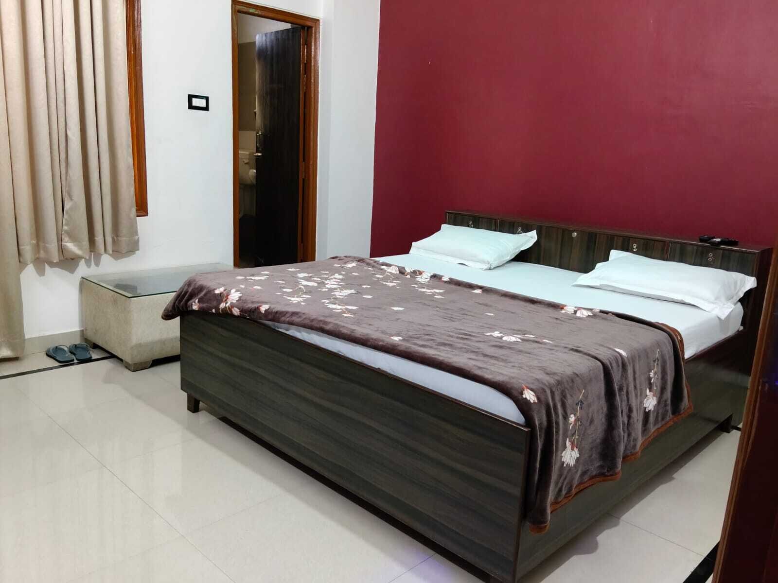 A bedroom with a bed, a bedside table, and a wardrobe.