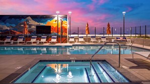An indoor swimming pool with lounge chairs and a mural on the wall. - 2 Condos + Rooftop Pool + Gym + Sauna | Desert Ridge | Azur by AvantStay (Phoenix)