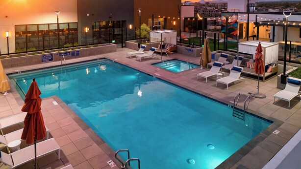 A rooftop pool area with multiple pools, sun loungers, and umbrellas. - 2 Condos + Rooftop Pool + Gym + Sauna | Desert Ridge | Azur by AvantStay (Phoenix)