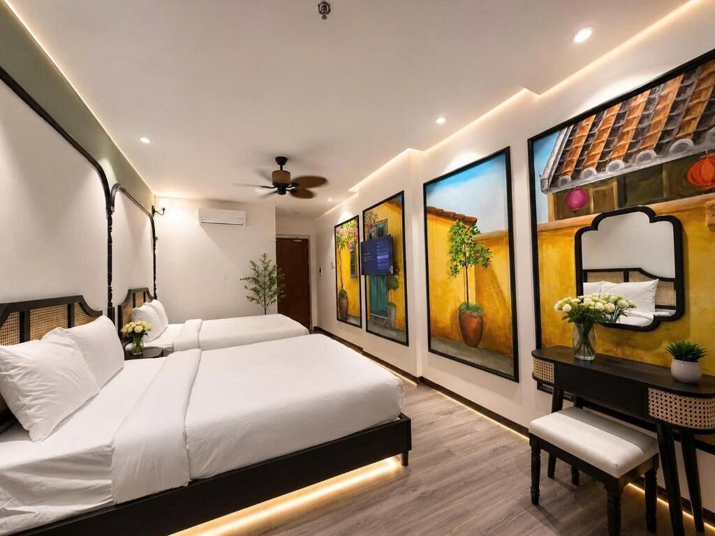 A modern hotel room with two beds, a desk, and artwork on the walls.