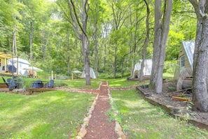 A wooded area with a gravel path, picnic tables, and a small building labeled 'PRIVATE PROPERTY.'