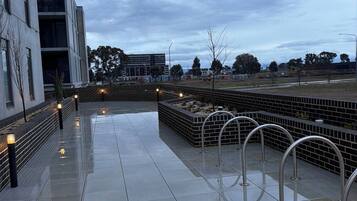 A modern building with a tiled walkway and metal railings.