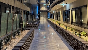 A modern building with multiple floors, a central atrium, and a reflective floor. - G6 Gungahlin brand new (Gungahlin)