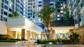 A modern hotel with a central courtyard, a water feature, and a large tree. - The Base Central Beachside Stay with Infinity Pool (Muang Pattaya)