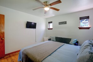 A bedroom with a bed, a ceiling fan, a television, a window with a view, and a motivational quote on the wall. - Family Apt 7 Mi to Gateway Arch, Museums & More! (St. Louis)
