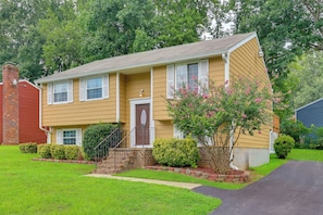 A two-story residential house with a front porch, a brick chimney, and a well-maintained lawn. - Charming Family Home 11 Mi to Dtwn Richmond! (Chesterfield)