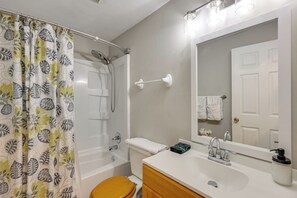 A bathroom with a shower, toilet, sink, and a mirror. - Charming Family Home 11 Mi to Dtwn Richmond! (Chesterfield)