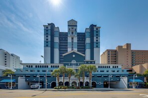 A hotel with a central tower, multiple entry points, and a parking area. - 15th-Floor Balcony! Myrtle Beach Oceanfront Oasis (Myrtle Beach)