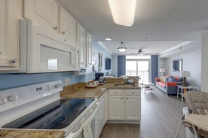 A modern kitchen with white cabinets, a built-in oven, and a granite countertop. - 15th-Floor Balcony! Myrtle Beach Oceanfront Oasis (Myrtle Beach)
