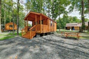 A wooden cabin with a porch and stairs, surrounded by trees. - Cozy Couple’s Cabin w/ Trail Access in Oxford (Oxford)
