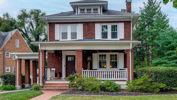 A two-story brick house with a front porch, a chimney, and a small attached garage. - Downtown Salem Home: Walk to Main Street! (Salem)