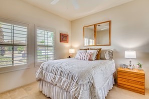 A bedroom with a bed, a nightstand, a mirror, and a window with blinds. - 2 Mi to Tennis Garden! Extended Retreat w/ Pool (La Quinta)