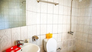 A bathroom with a toilet, sink, and shower. - Rainbow Executive Lodge (Boma Ng'ombe)