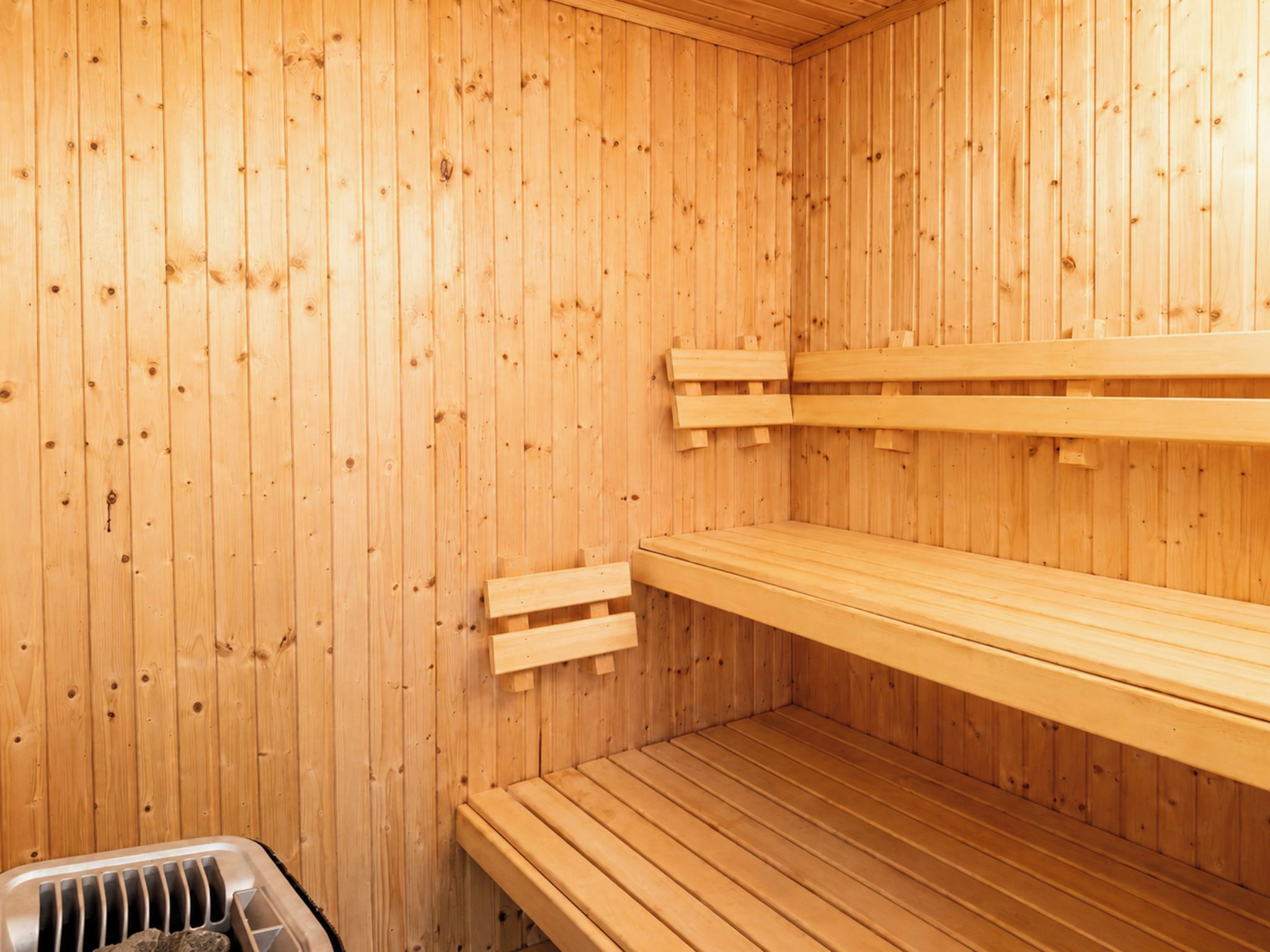 A sauna with wooden walls and benches.