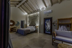 A bedroom with a bed, bedside tables, a wardrobe, and a large wall with a textured design. - AETHER - Romantic Private Pool Villa with Spectacular Ocean Views (Corfu)