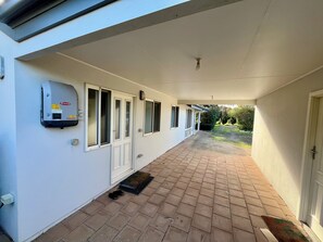 A covered corridor with a water heater, a door, and a window. - Birdies Beach House - Relaxing & Cosy Beach house on Kangaroo Island (Baudin Beach)