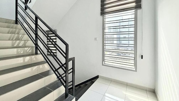 A staircase with a metal railing, a window with blinds, and a white tiled floor. - Chapter 6 by Nature Home (Kuantan)