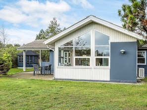 A house with a large glass window, a covered patio, and a blue shed. - 6 Person Holiday Home in Saeby (Sæby)