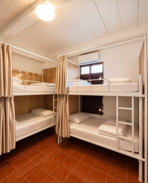 A bunk bed room with a window, curtains, and a ceiling light. - Green Hill Hostel (Vientiane)