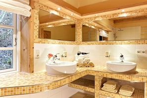 A bathroom with two sinks, a large mirror, and a window. - Holiday home with 1 bedroom (Groß Zecher)
