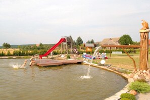 A water park with a slide, a small pool, and a wooden structure. - Holiday apartment with 2 bedrooms (Märkische Heide OT Biebersdorf)