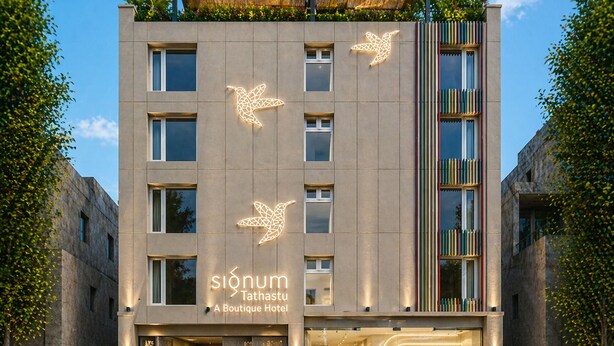 A modern boutique hotel with a unique geometric facade, multiple windows, and a visible entrance with a car parked outside. - Signum Tathastu Boutique Hotel- Haridwar (Haridwar)