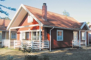 A red wooden house with a white porch and a chimney. - Swedish House Red Water Lily (Userin)