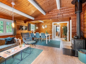 A cozy cabin interior with a dining area, a sofa, and a fireplace. - "Marjanna" - 500m to the fjord by Interhome (Ulfborg)