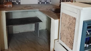 A compact kitchen with a built-in stove, a sink, and a small countertop. - Hotel Welcome (Indore)