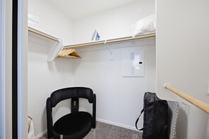 A compact room with a bunk bed, a chair, a small shelf, and a power outlet on the wall. - Location • Pool • Lux Gym • Free Parking • Cozy Retreat • Fireplace (Phoenix)