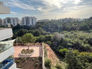 A rooftop terrace with a circular garden, surrounded by dense greenery and residential buildings in the background. - 3 Bedroom, 2 bathroom Greenhills apartment, indoor pool, gym, spa childrens park (Los Dolses)
