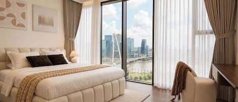 A modern bedroom with a large bed, a view of a cityscape, and a city bridge.