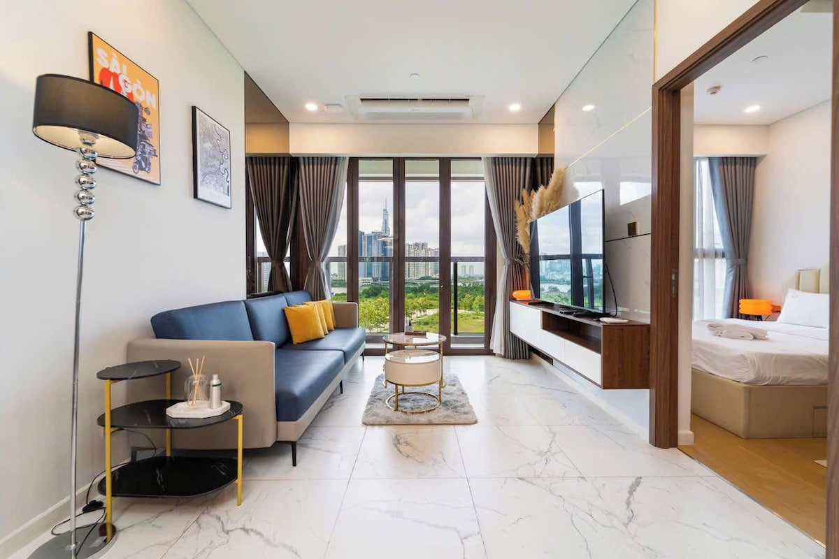 A modern living room with a sofa, a coffee table, and a TV.
