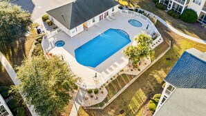 An aerial view of a residential property with a swimming pool, a covered patio, and a fenced yard. - 2BR 2BA condo. Ocean Keyes. 3rd flr. Elevator. Pool view. Short walk to beach. (North Myrtle Beach)