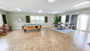 A spacious indoor area with a pool table, a ping pong table, and a billiards table. - 10% off 3-7 nights thru Oct. 2BR 2BA condo. 3rd flr. Elev. Pool view. Short walk to beach. (North Myrtle Beach)
