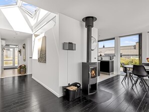 A modern interior with a wood-burning stove, skylights, and a dining area. - "Lin" - 80m from the sea by Interhome (Haderslev)