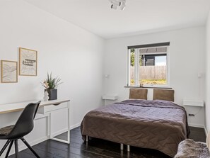 A bedroom with a bed, a desk, a chair, a window, and a view of the outside. - "Lin" - 80m from the sea by Interhome (Haderslev)