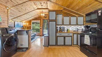 A modern kitchen with wooden cabinets, a built-in oven, and a large refrigerator.