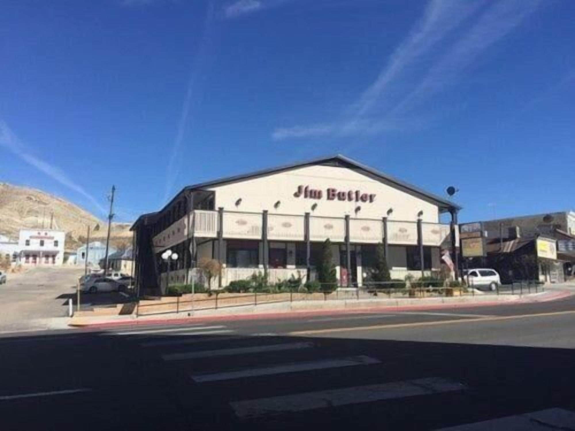 A building with a flat roof and a sign that reads 'Jim Butler.'
