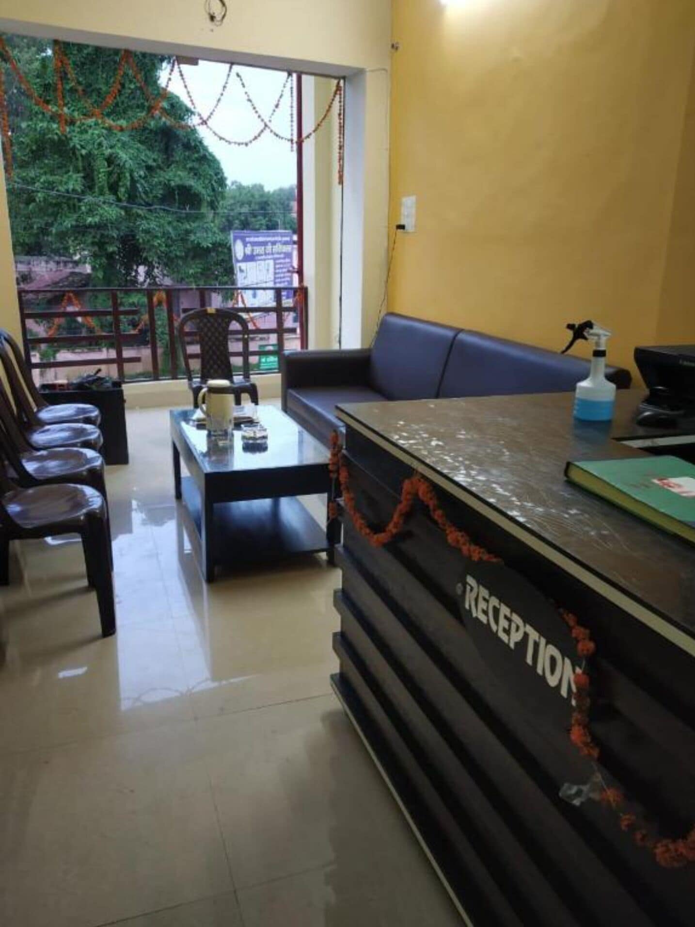 A reception area with a counter, seating, and a view of the outdoors.