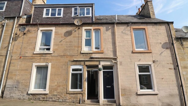 A two-story residential building with a flat roof, multiple windows, and a front door. - HILL VIEW STUDIO, with a garden in Hawick (Hawick)