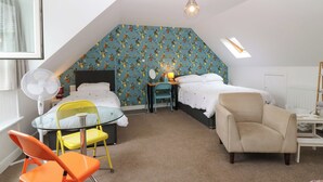 A bedroom with a sloped ceiling, two beds, a desk, a chair, and a fan. - HILL VIEW STUDIO, with a garden in Hawick (Hawick)