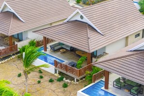 A resort with multiple overwater bungalows, each with a private pool and outdoor seating area. - Villa Zaya Blue Bay Private Pool Golf View (Sint Michiel)