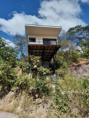 A modern two-story building with a flat roof and a balcony on the upper floor. - w Cozy 2BR Near Playa Grande w Mountain Views (Cabo Velas)