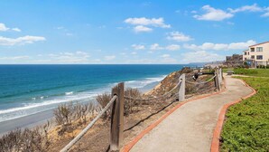 A coastal walkway leading to a beach with a clear view of the ocean and distant mountains. - Starfish Siesta - new listing! renovated condo with tennis, pool and patio (Solana Beach)