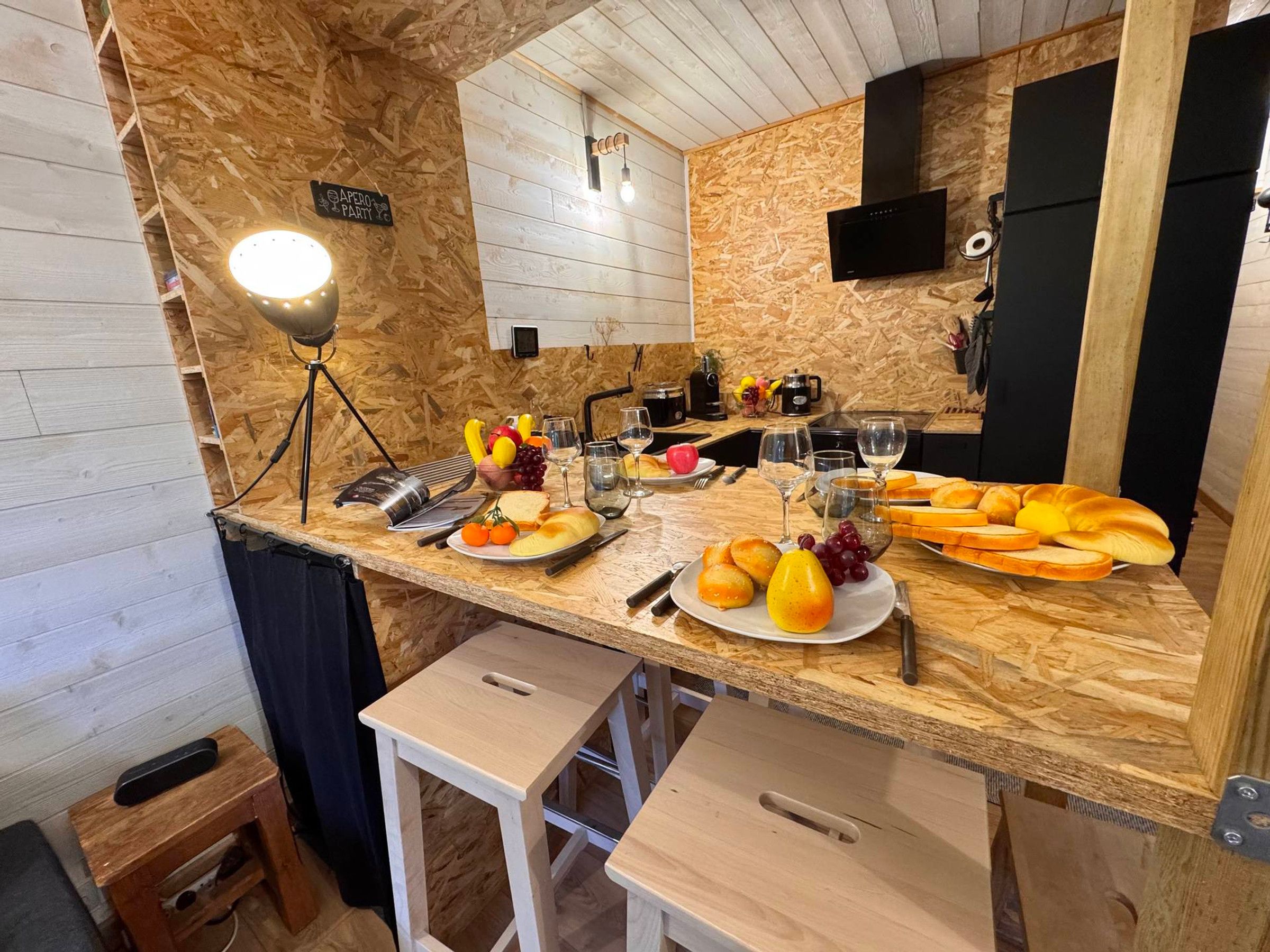 A kitchen with a wooden countertop, a coffee machine, and a sign indicating a party area.
