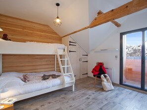 A room with a bunk bed, a ladder, a chair, a window, and a door. - Spacious chalet mountain view - 10 guests (Les Deux Alpes)